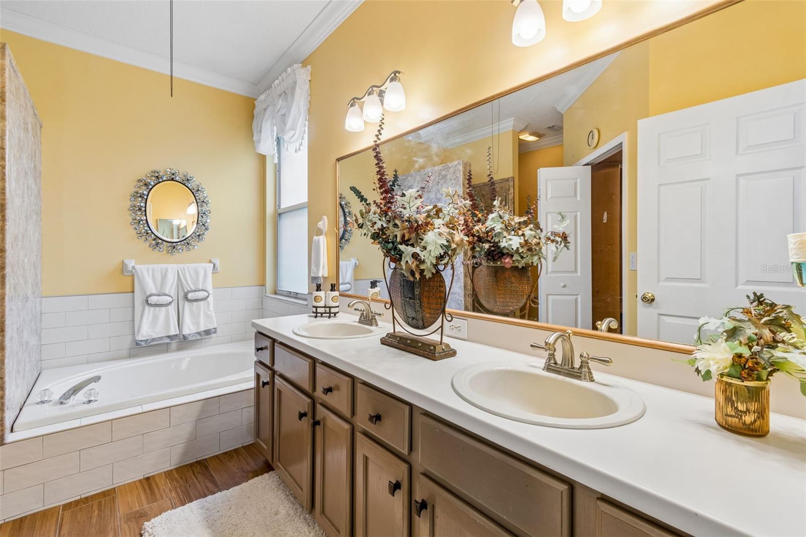 PRIMARY BATHROOM  WITH SOAKING TUB WITH LOTS OF NATURAL LIGHT