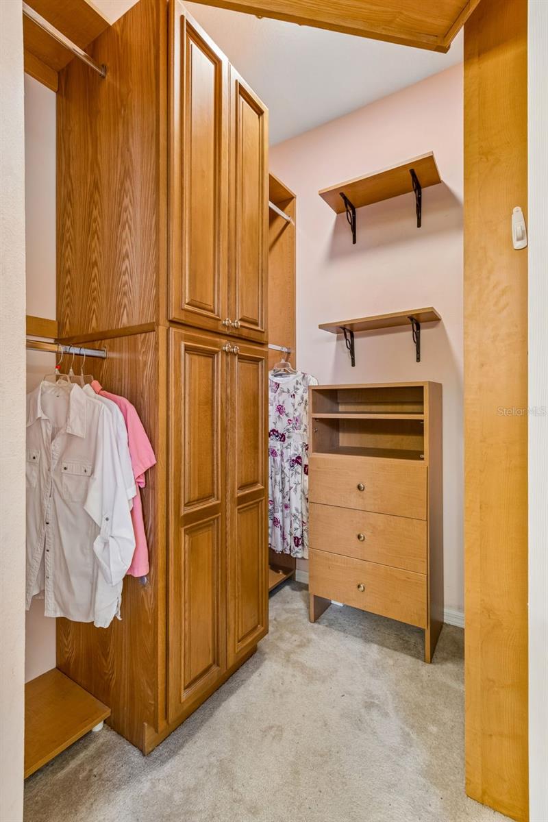 PRIMARY BATHROOM CUSTOM CLOSET WITH OVERHEAD CABINETS AND SHELVING