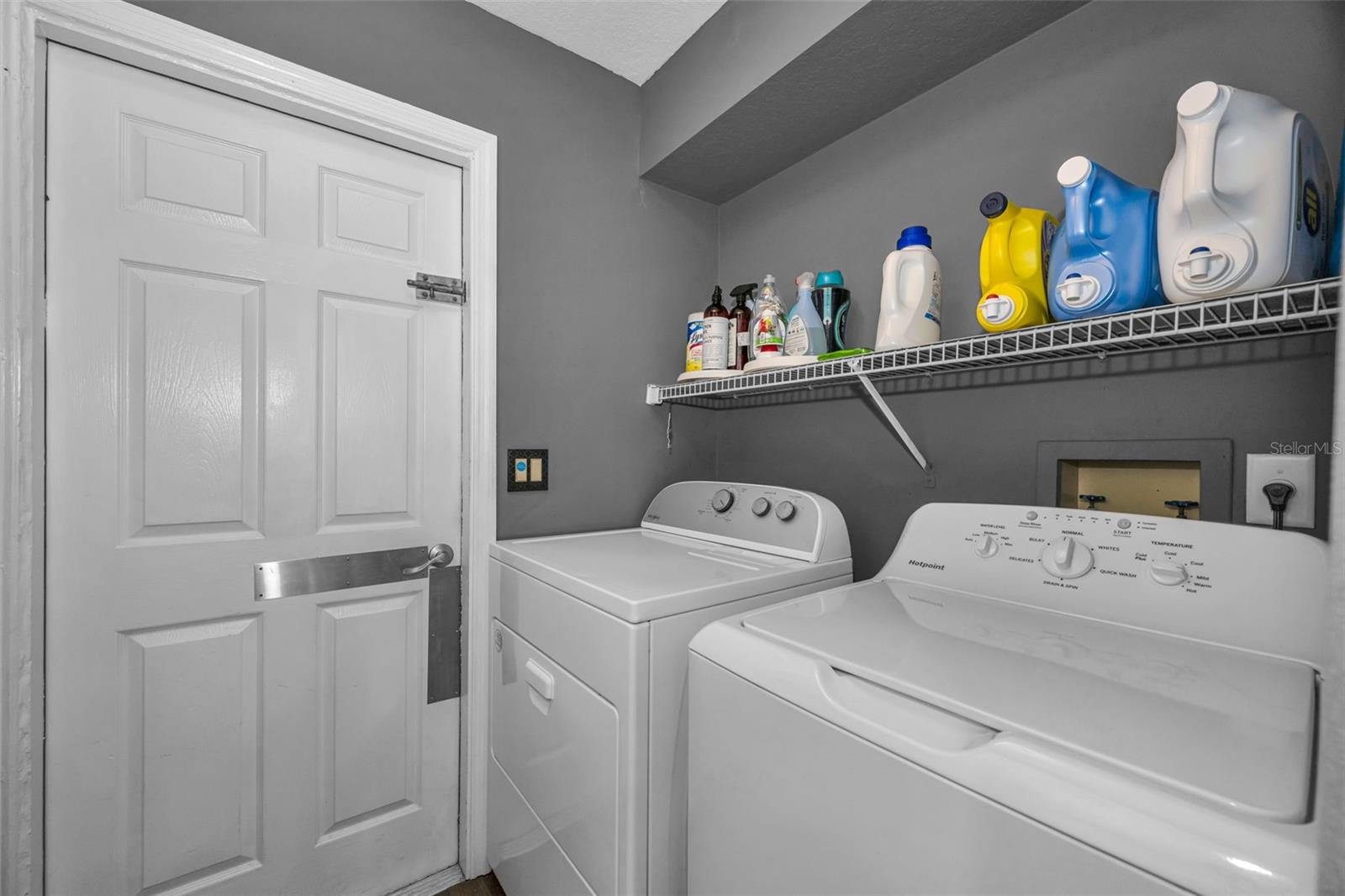 Laundry room with Laundry sink & storage closet.