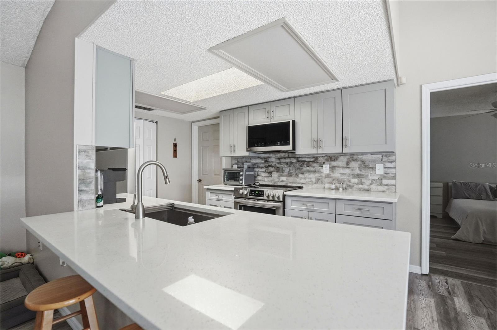 Remodeled kitchen with Large Quartz Breakfast Bar for extra seating!