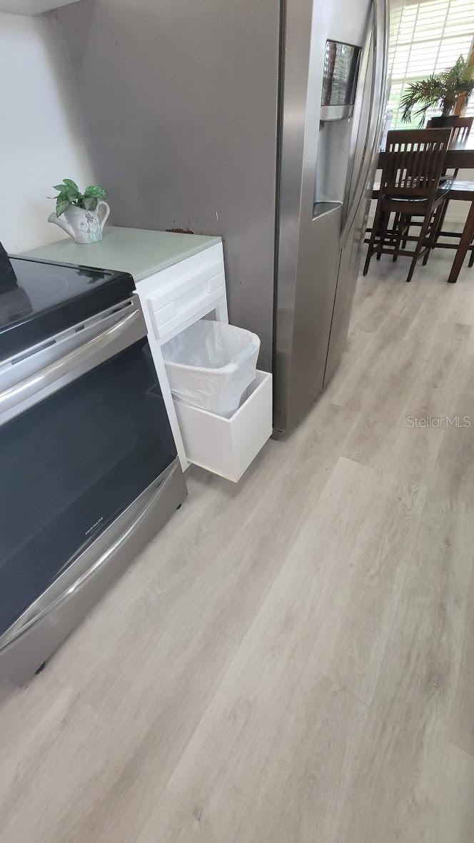 Trash can cabinet with pull out drawer