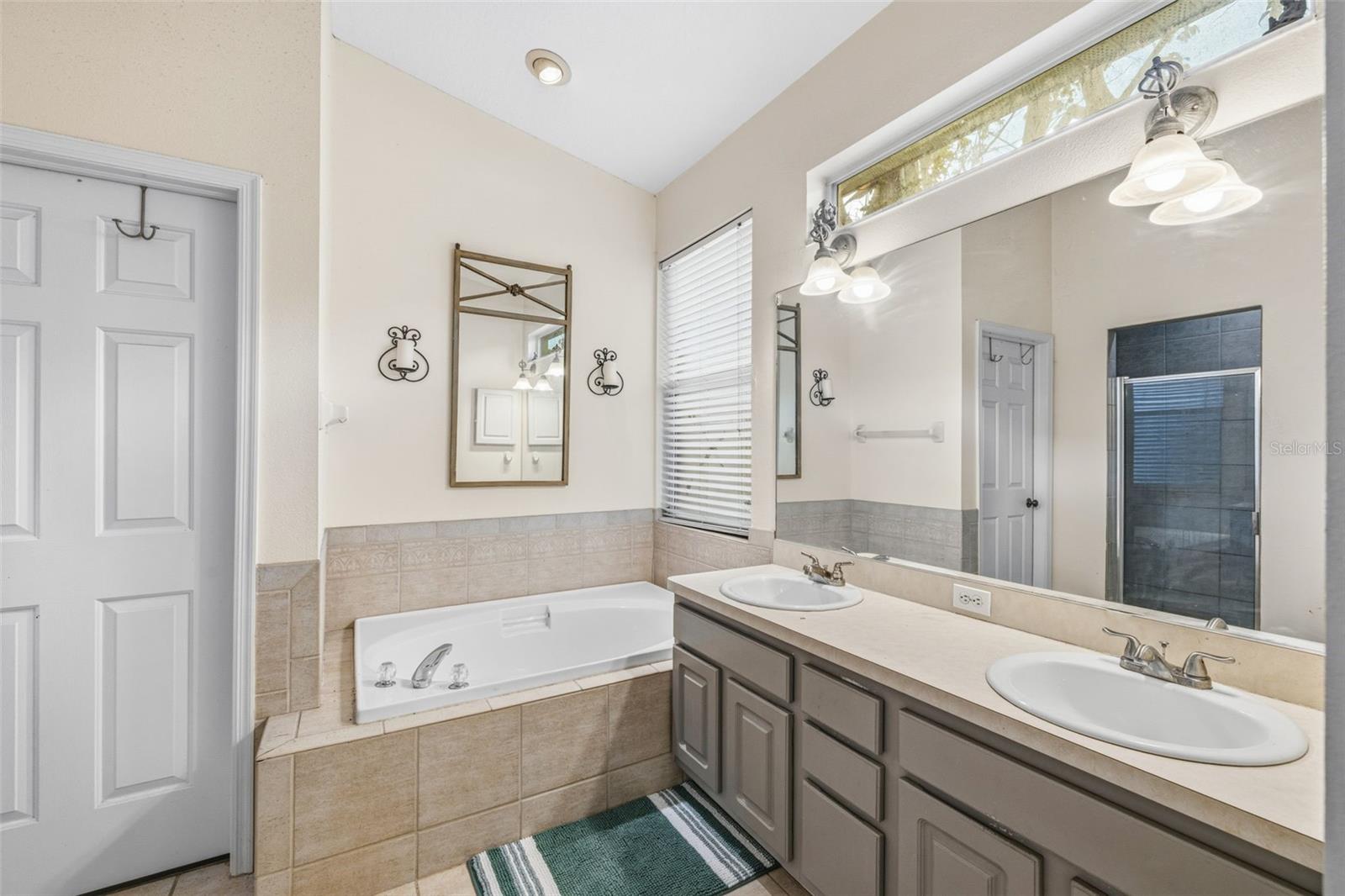 Primary bathroom with large soaking tub, dual sink vanity, walk-in shower and private water-closet.