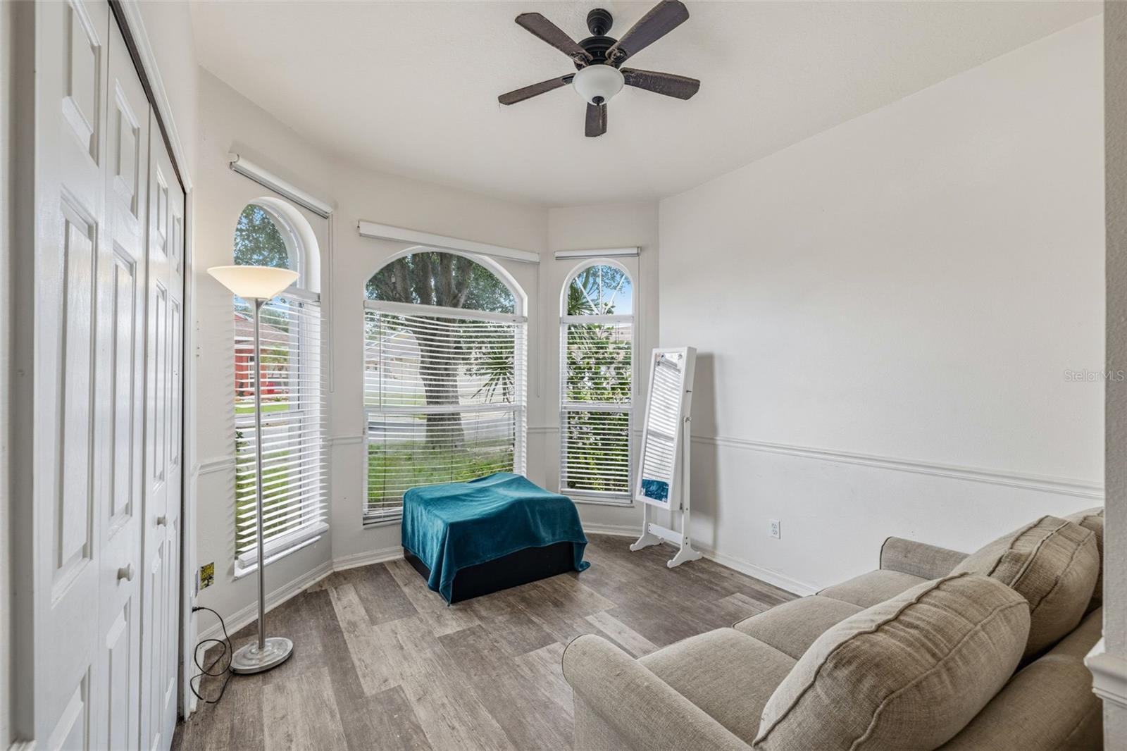 Bedroom #2 features large arch framed windows and joins the primary bath.  This can be used another bedroom or possibly a primary sitting room/private office.