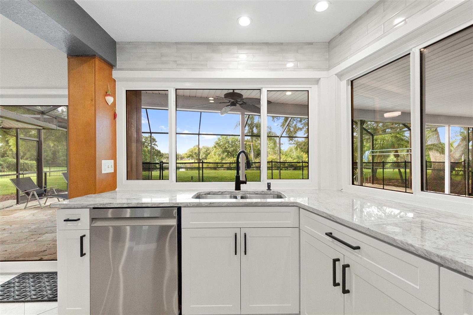 Kitchen access to pool area and screened in patio