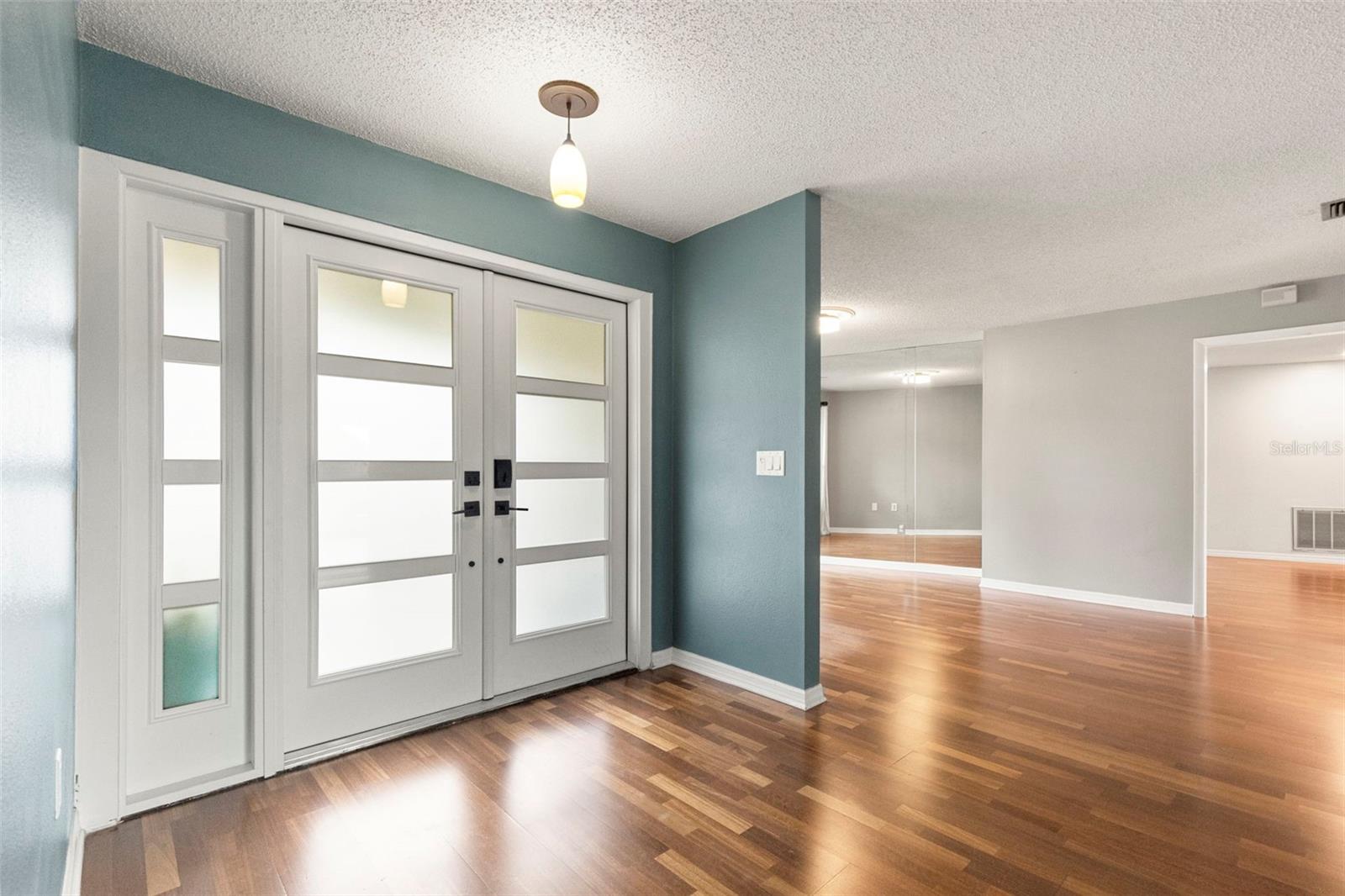Front door entry with view of formal dining area