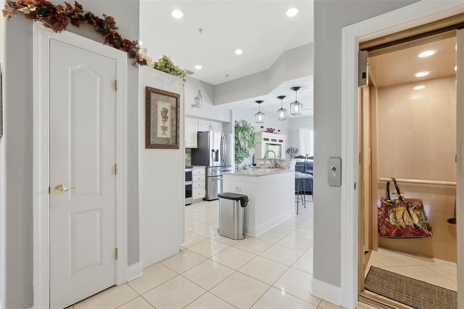 2nd level features high ceilings, a kitchen with an oversized quartz island opening into spacious waterfront living area with balcony and wide water views!
