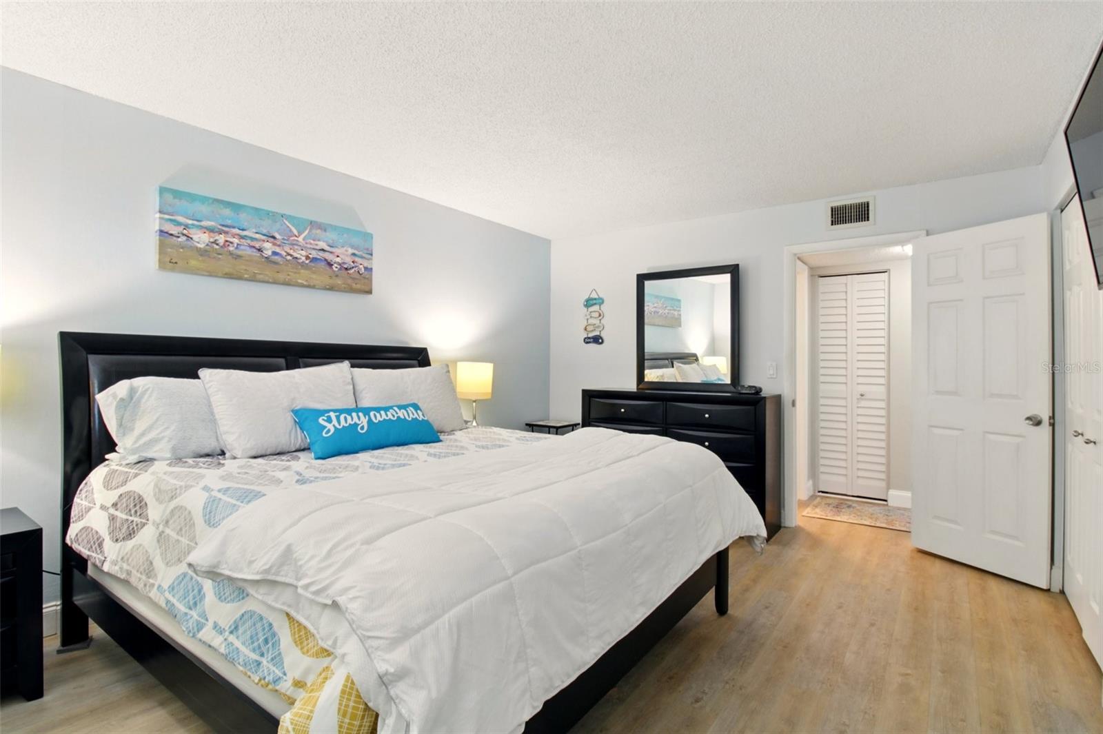 The inviting bedroom offers a peaceful retreat with abundant natural light and a comfortable, relaxing atmosphere.