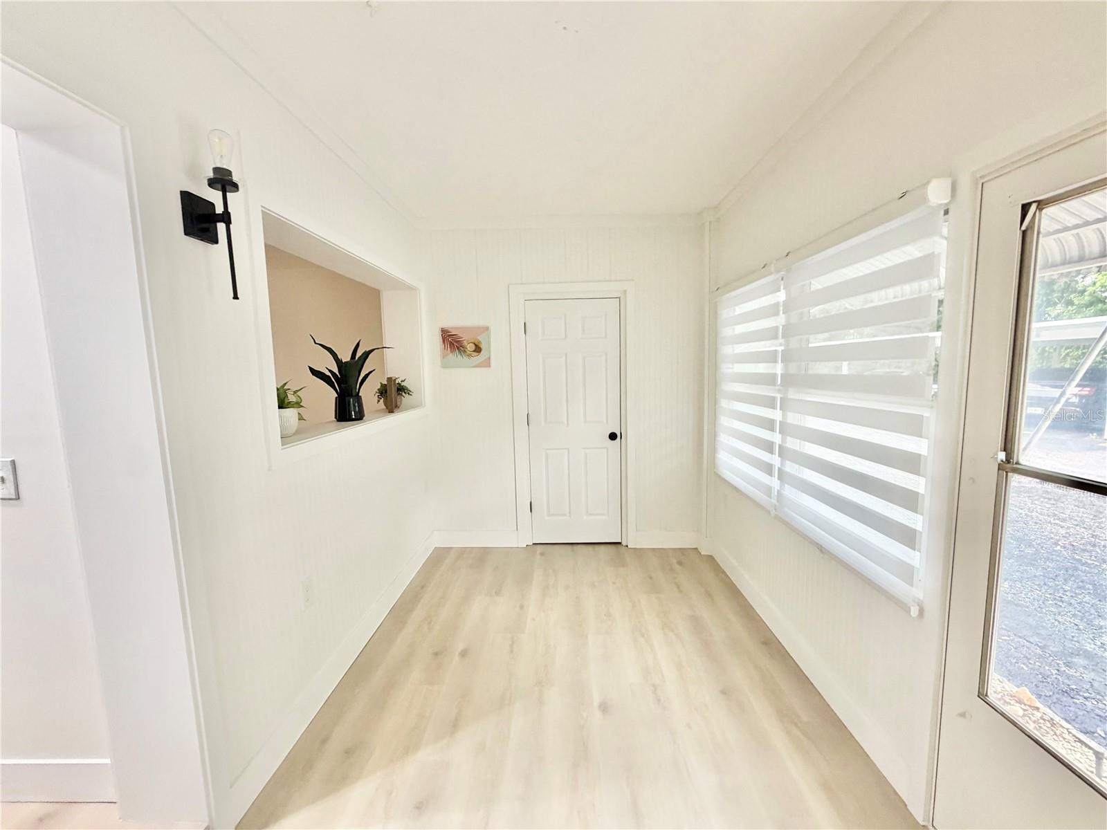 Sunroom with storage closest.