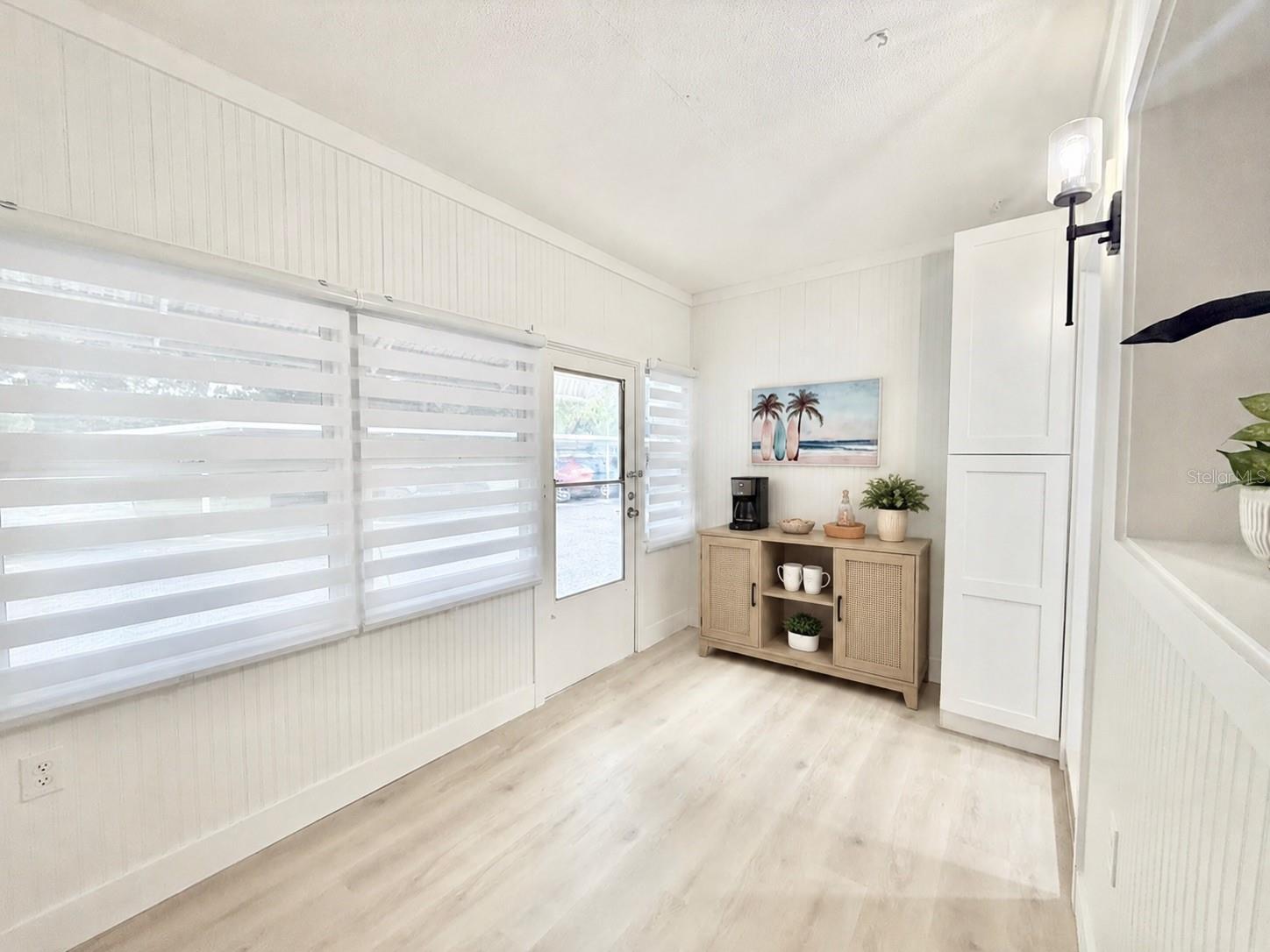 Spacious sunroom with exterior door to covered parking.