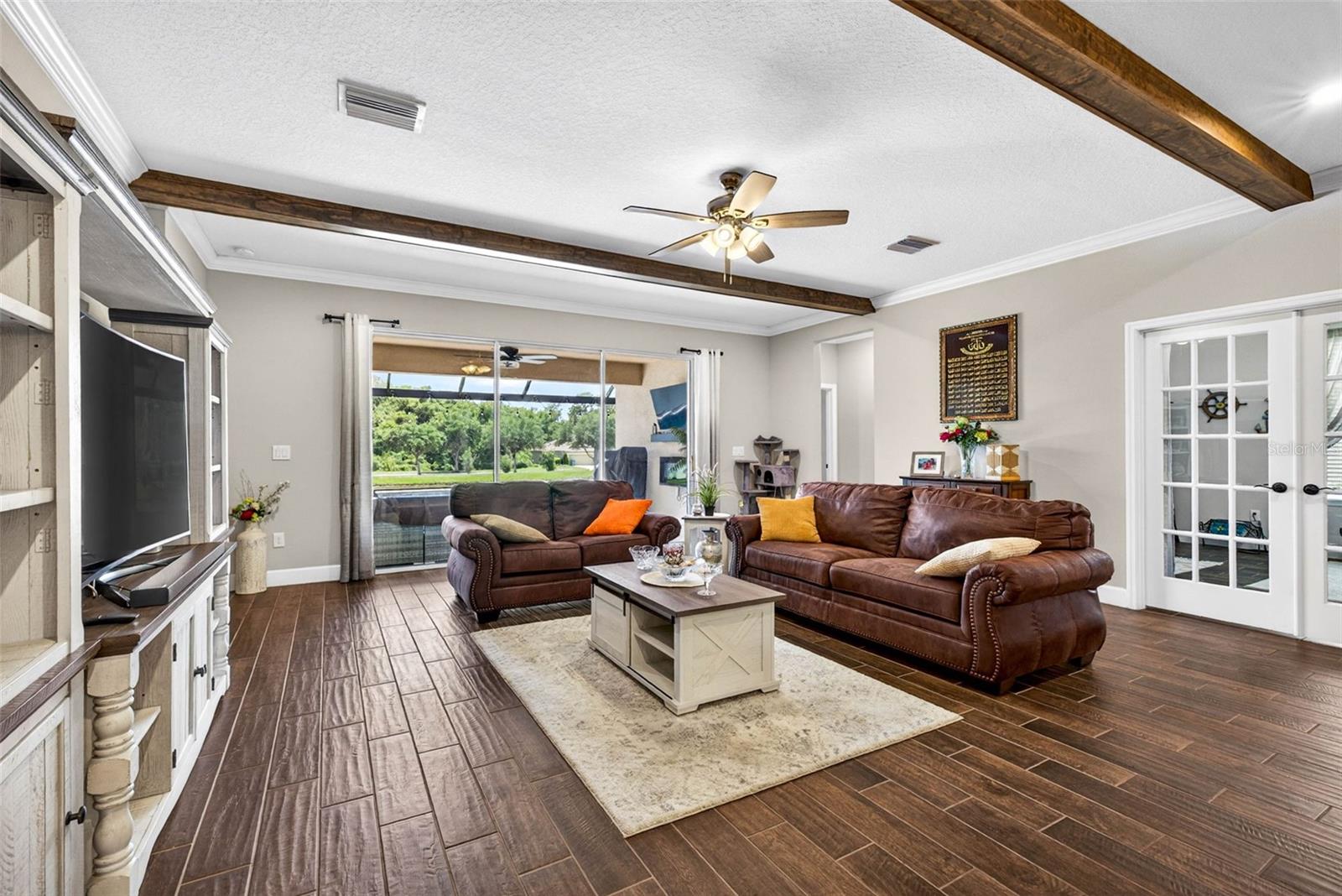 Living room leads to office with 2x glass doors