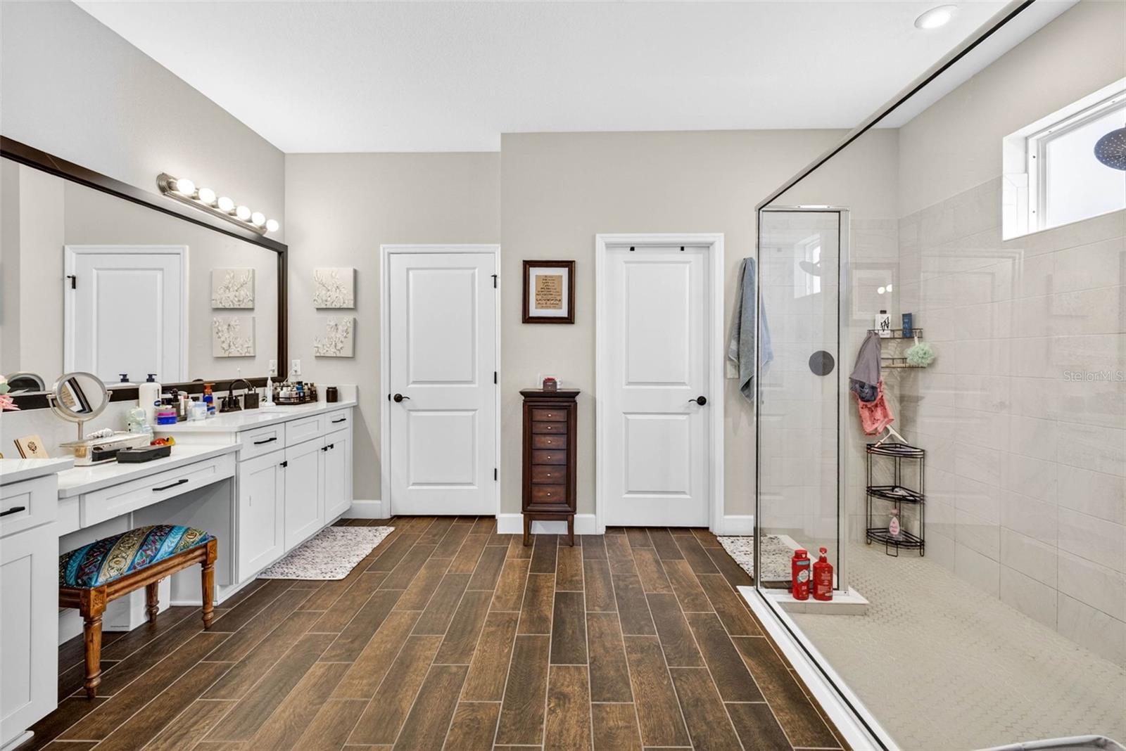Primary bath with vanity, dual sinks and walk in elongated shower.