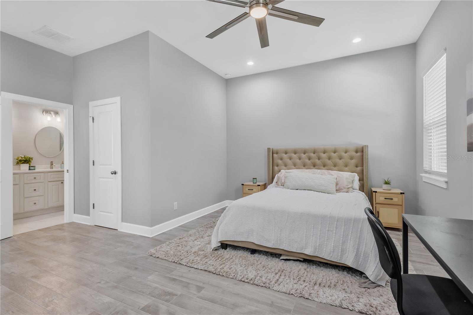 Expansive primary bedroom is a private oasis