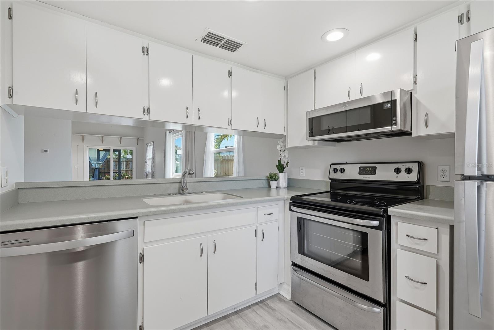 Greeted by the bright kitchen with stainless steel appliances.