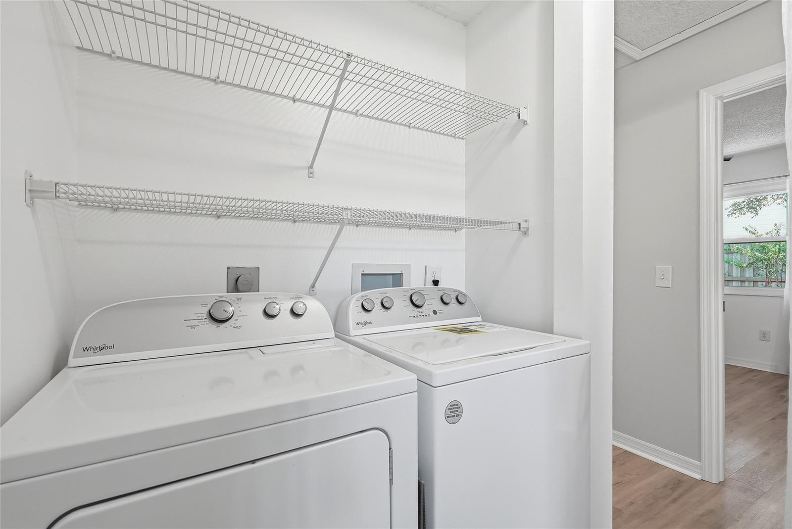 Inside laundry with newer full size washer and dryer.