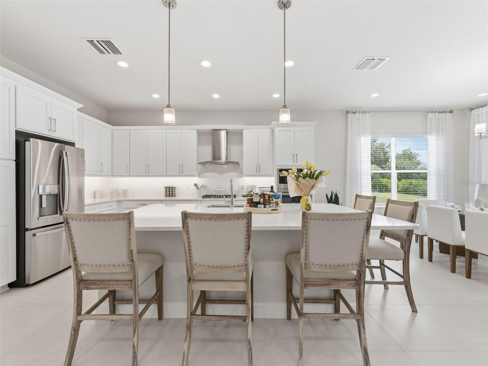 This kitchen features an oversized island with casual seating.