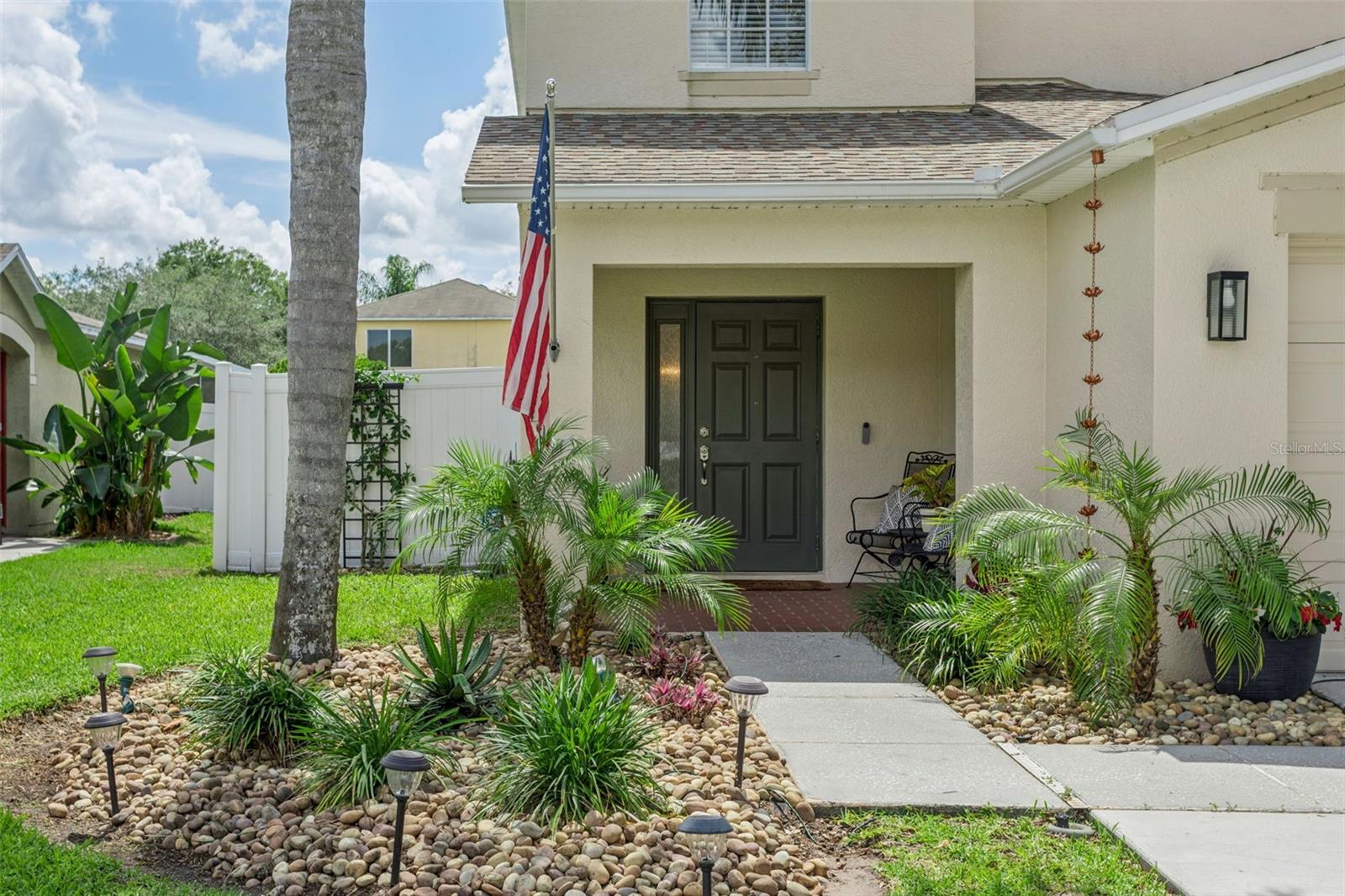 Walkway to the front door with a sitting area