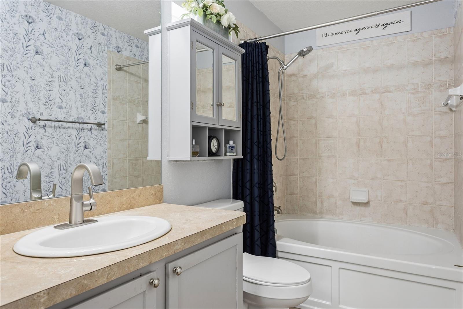 Master suite bathroom with a garden tub shower combination