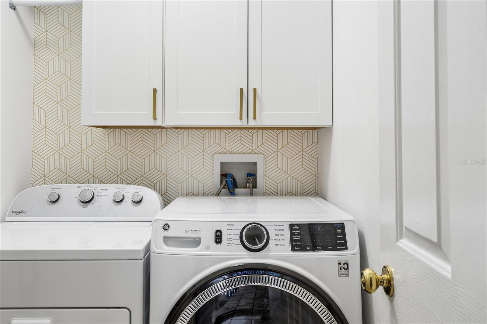 Laundry room has cabinets.