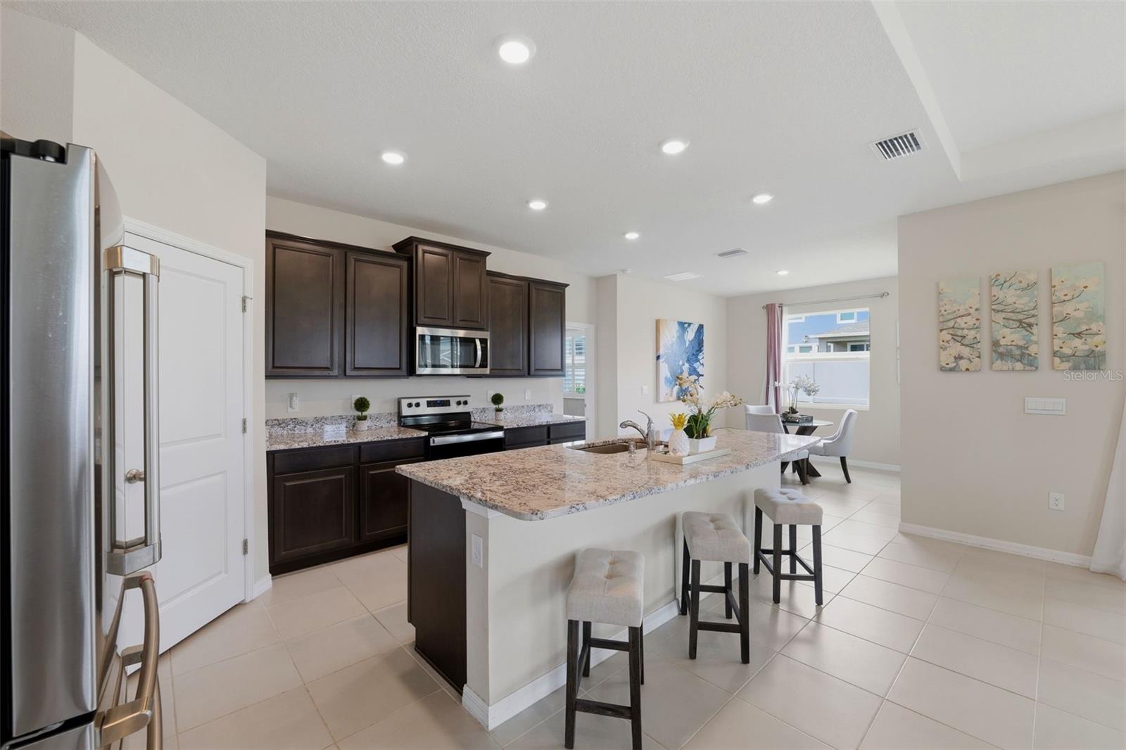 Gourmet Kitchen with Granite Counters, Breakfast Bar and Walk in Pantry