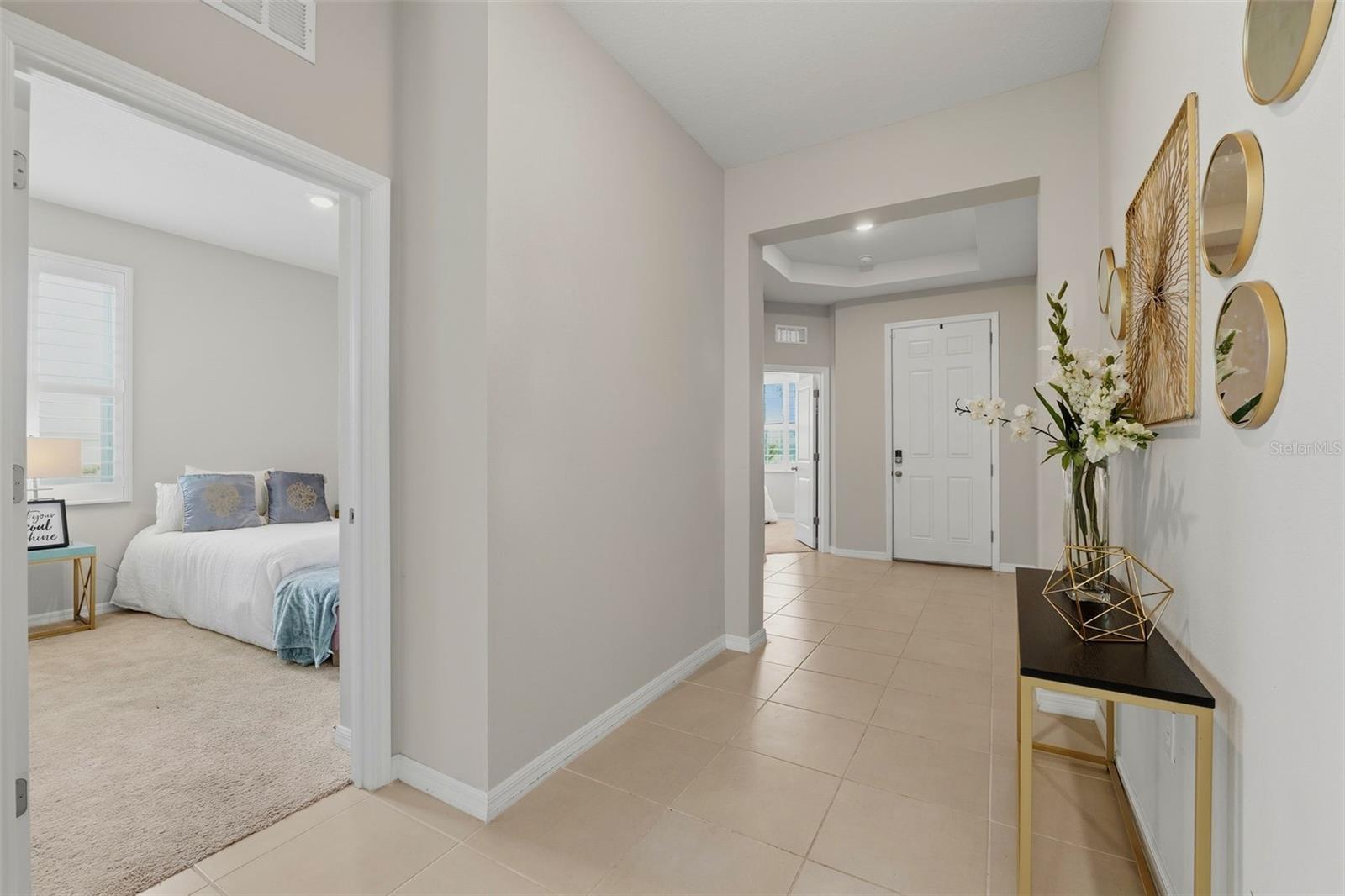 Grand foyer entrance with a convenient guest room upfront