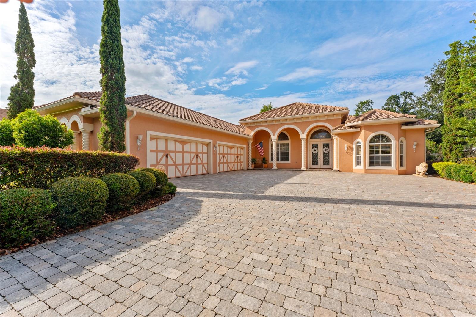 Grand paved drive and motor court and oversized 4 car garage