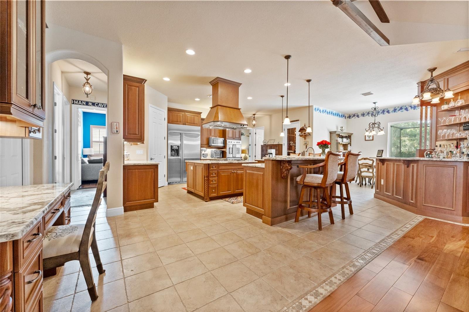 Gourmet kitchen with upgraded appliances, breakfast bar, & built-in desk
