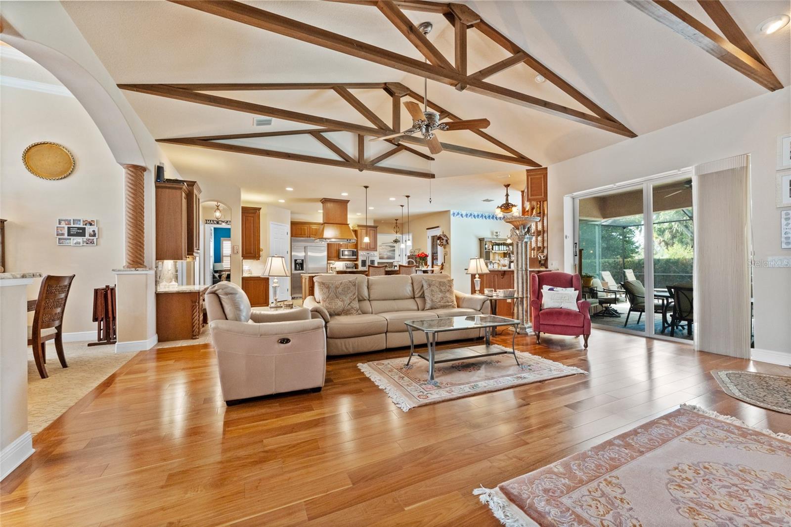 Open floorplan; living area with wood flooring