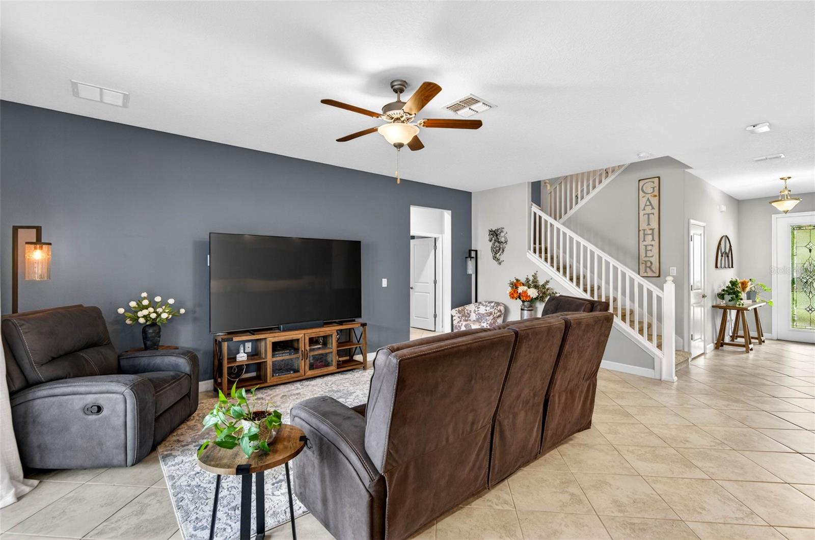 Large living area with foyer and stairwell leading to second floor