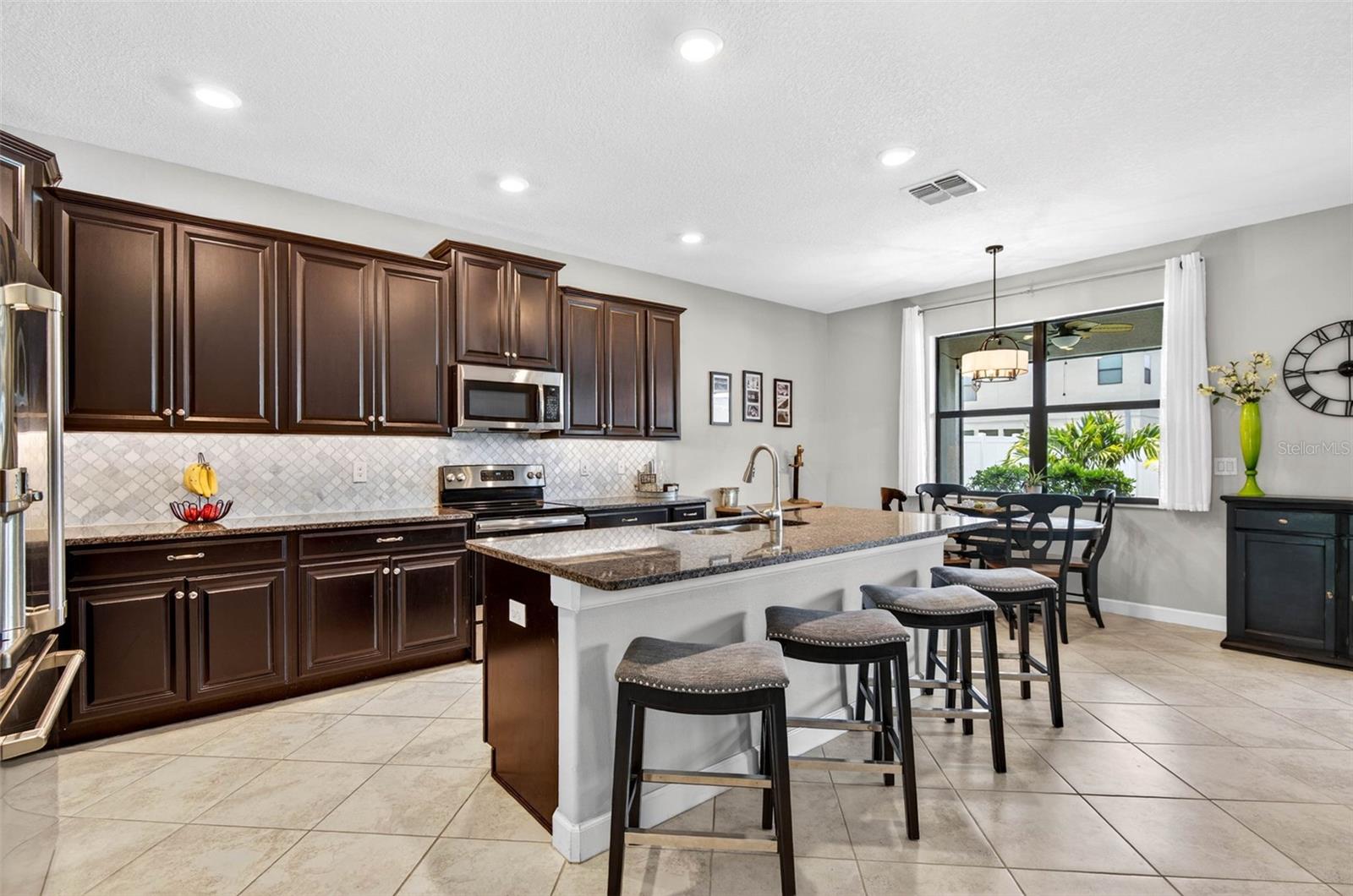 Kitchen with large island, granite countertops, 42" wood cabinets with crown molding