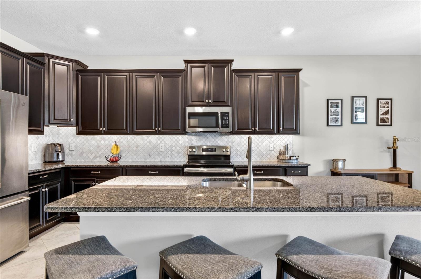 Large kitchen island with 42" cabinets and plenty of granite countertop space