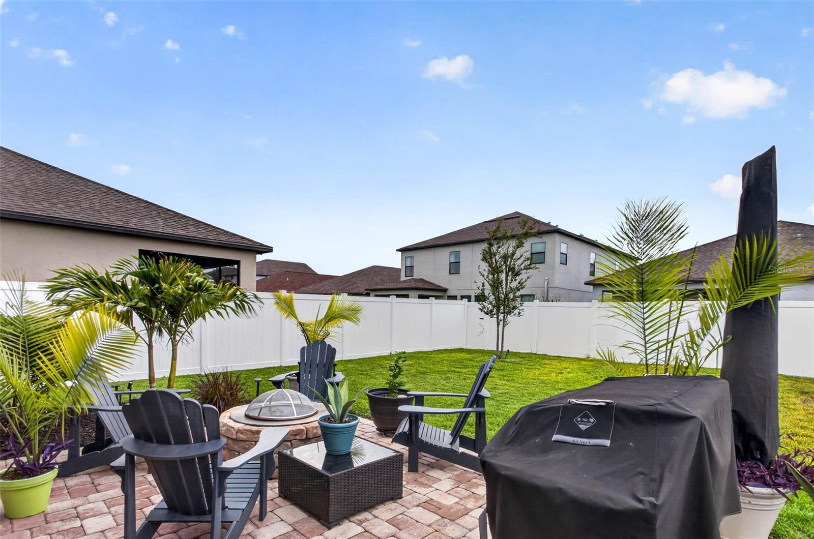 Extended pavered area with firepit.