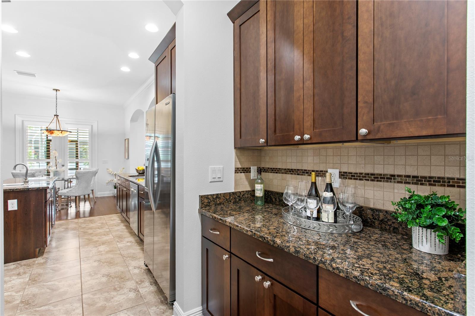 Conveniently positioned between the kitchen and dining room, the dry bar enhances both function and flow.