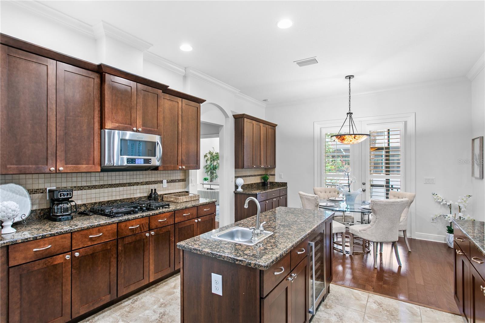 A charming breakfast nook provides the perfect setting for informal meals and connects effortlessly to the covered outdoor living area.