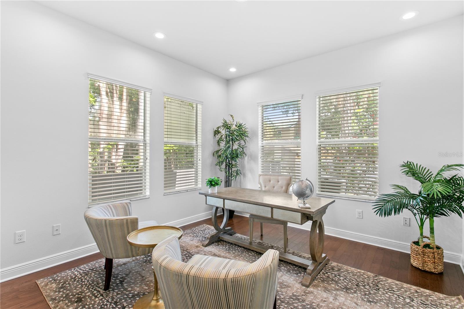 An additional room tucked just off the kitchen provides the perfect spot for a home office, homework station, or creative workspace.