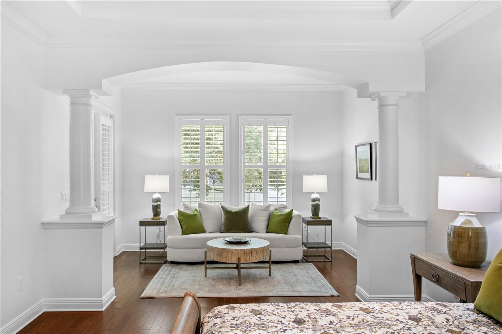 A rare first-floor primary suite complete with a spacious sitting area