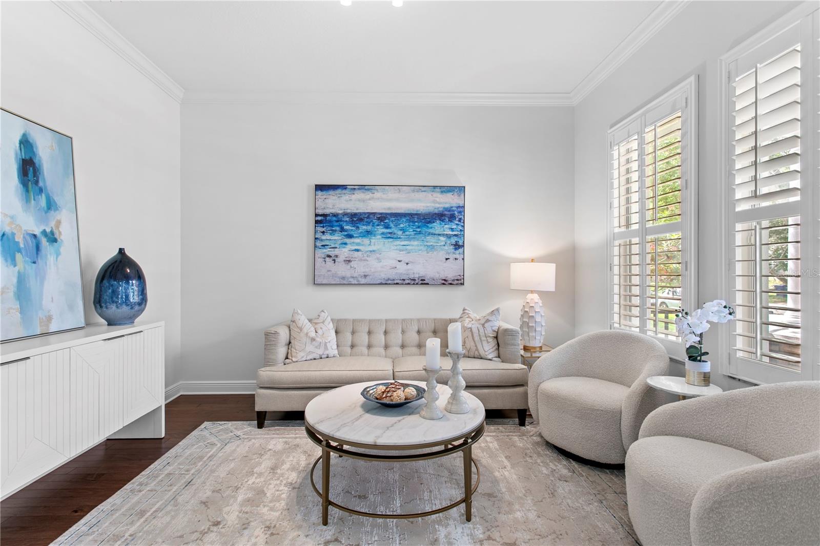 Just off the foyer, French doors lead to a versatile flex space that can serve as a private home office, playroom, study, or quiet retreat.