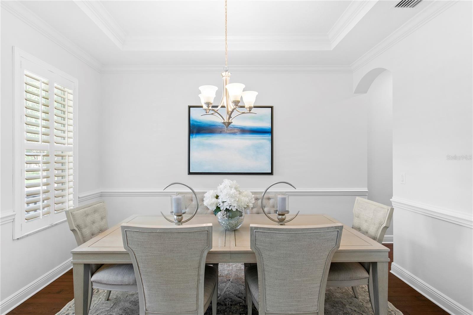 The thoughtfully designed floor plan seamlessly connects the formal dining room, complete with a dry bar, to the expansive kitchen and family room