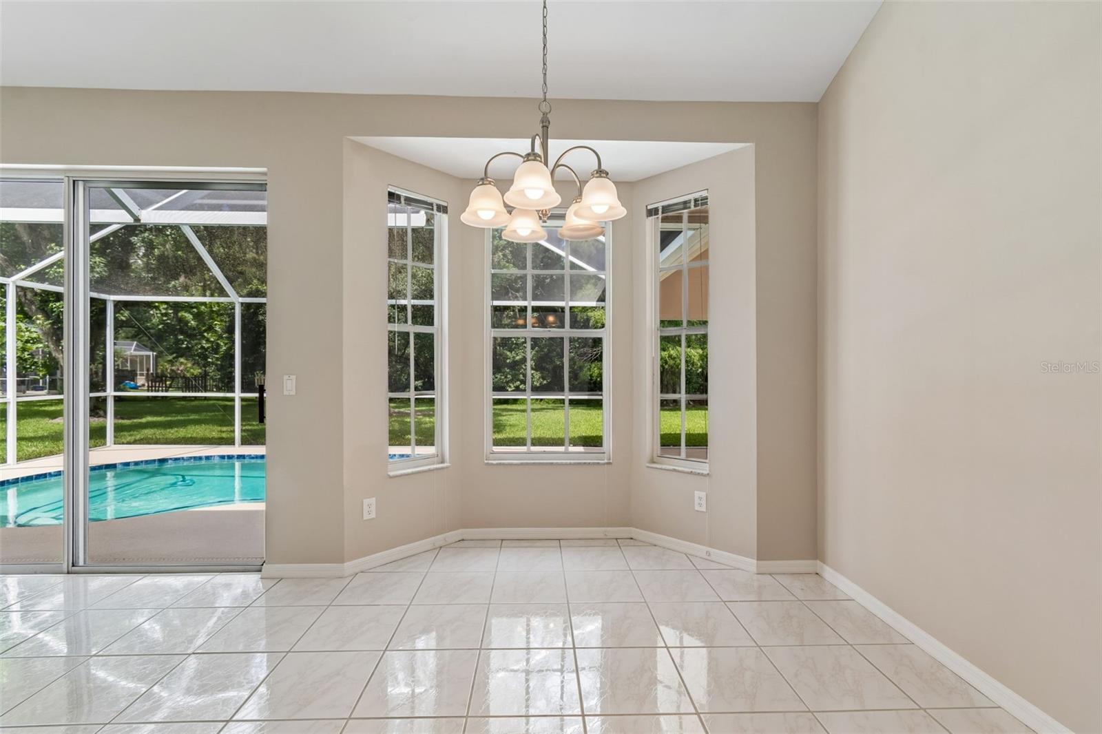 Dining Room with bay window and a pool view