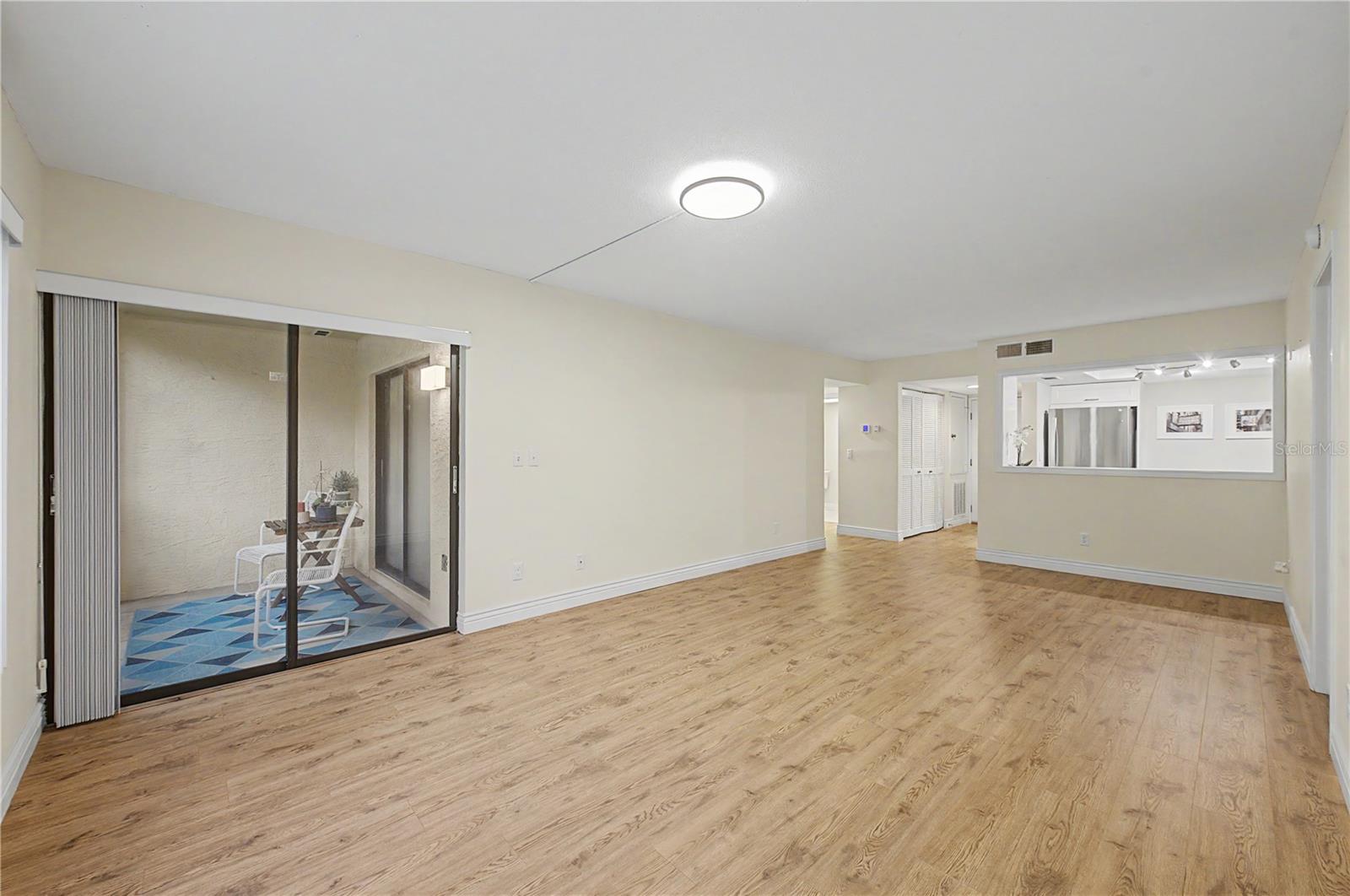 OPEN LIVING AREA leads out to your BIG, PRIVATE, SCREENED PATIO!