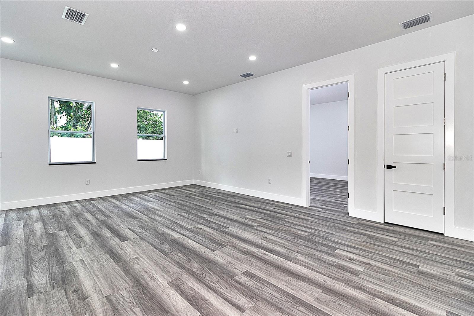 Great Room with Primary Bedroom thru open door