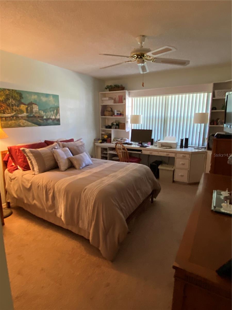 Bedroom 2 has custom built in desk and book cases
