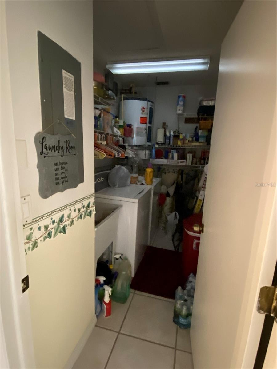 Inside laundry room with washer, dryer, and utility sink and storage space