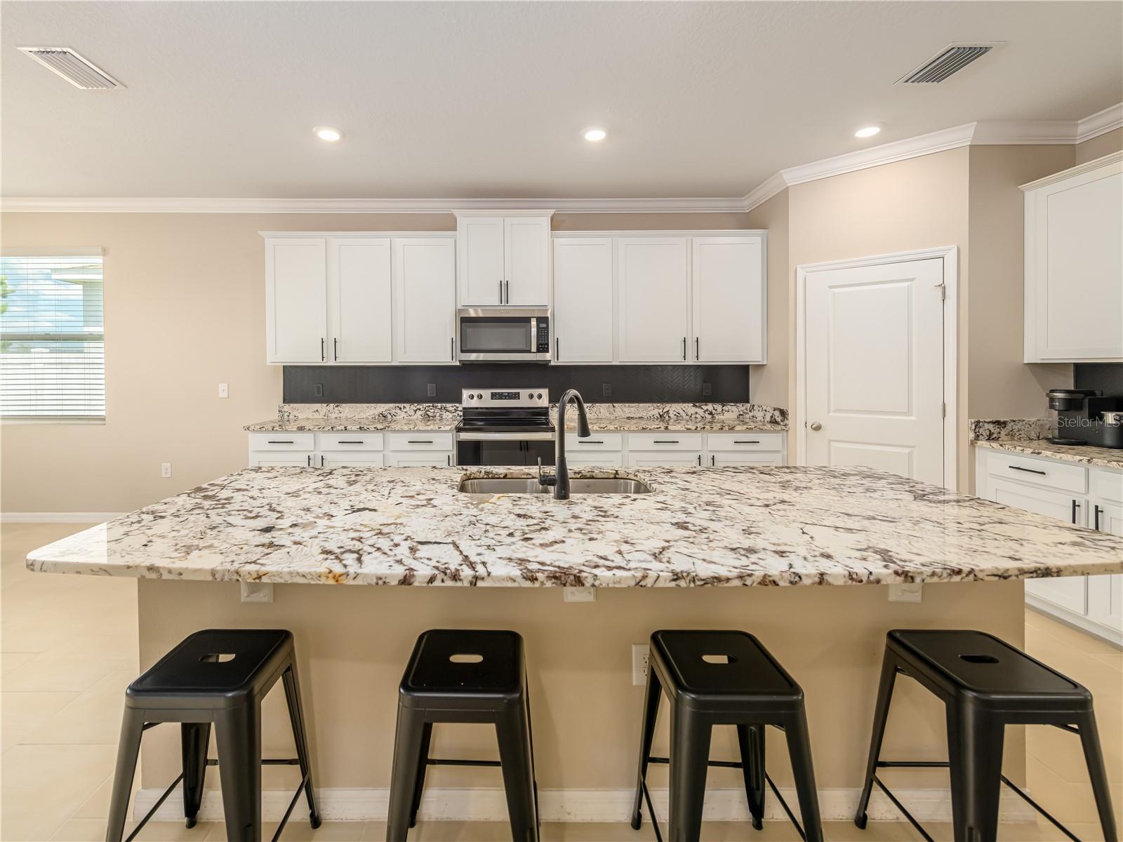 Granite countertops with lots of room to prep meals