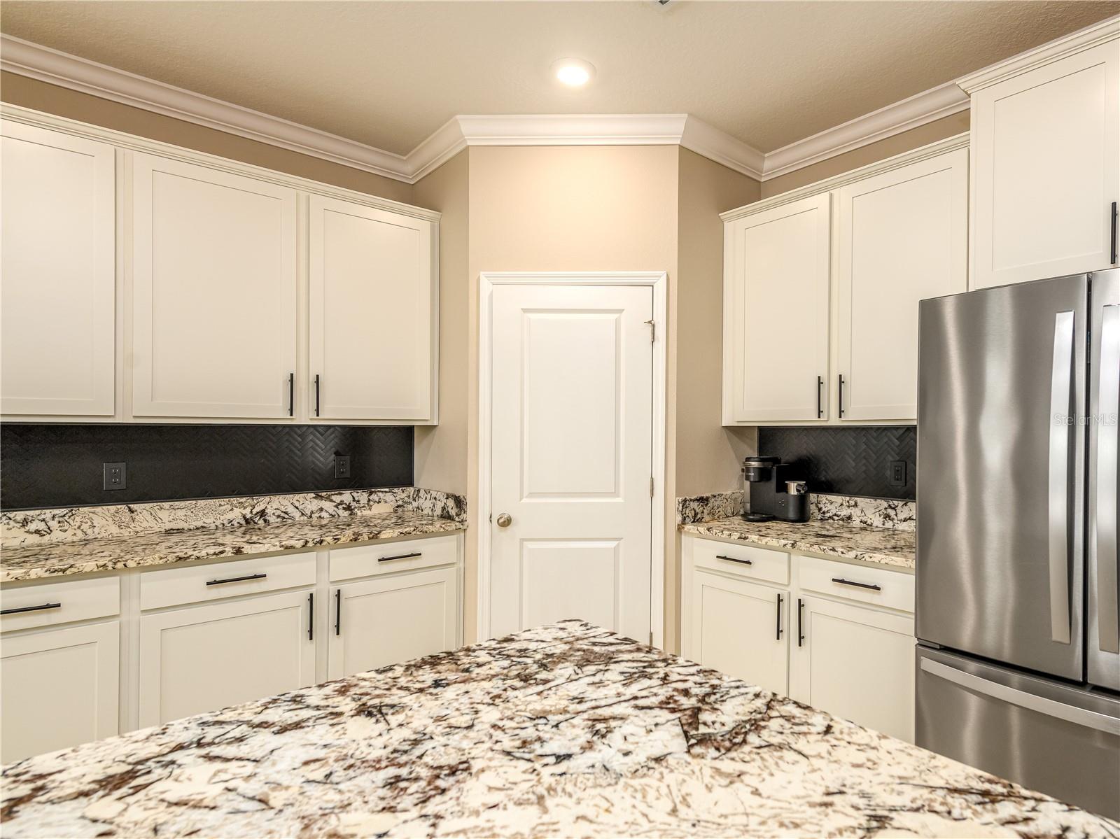 Stainless steel appliances with tile backsplash