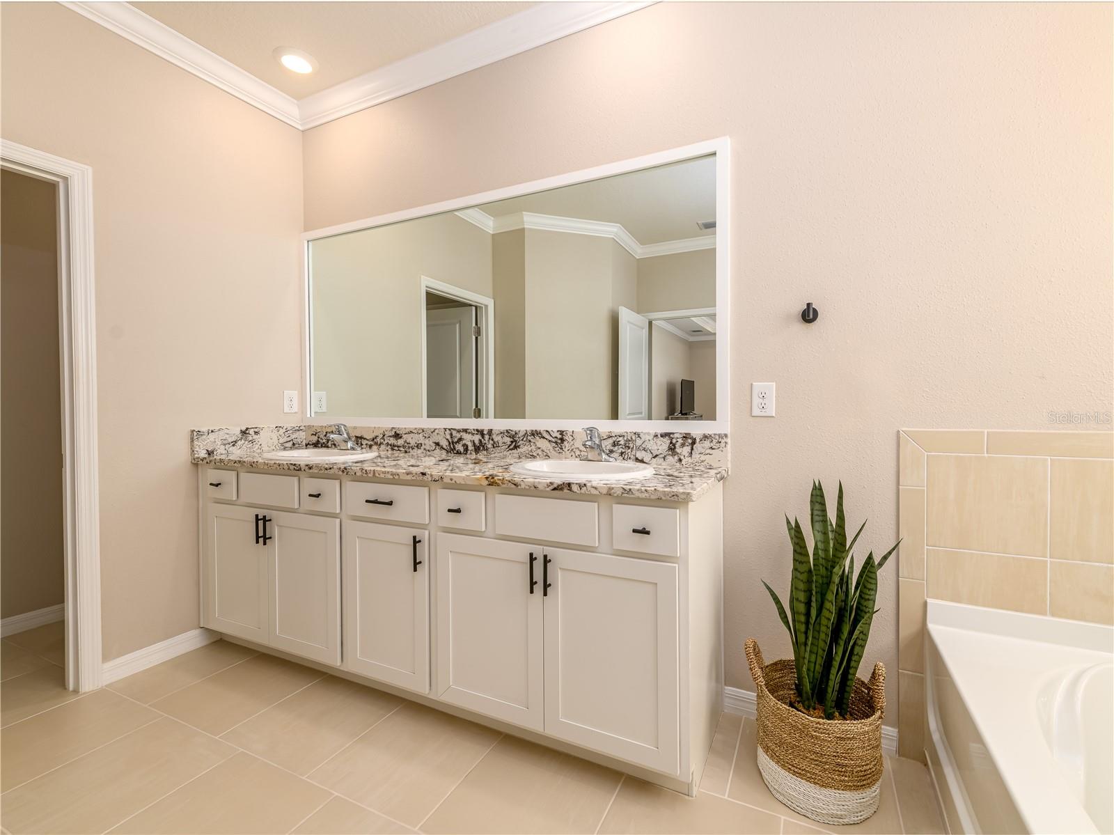 Primary bathroom with dual vanities