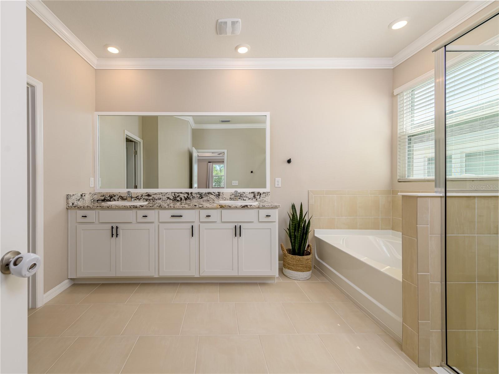 Ensuite with dual vanities, tub & shower