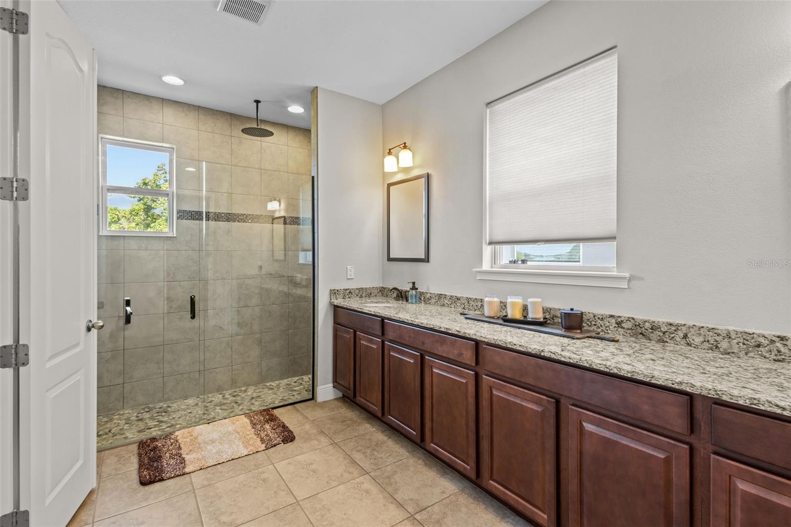 Primary bath with walk-in shower and generous storage