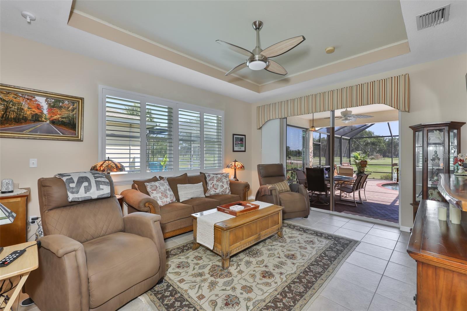 Living room with lovely tray ceiling.
