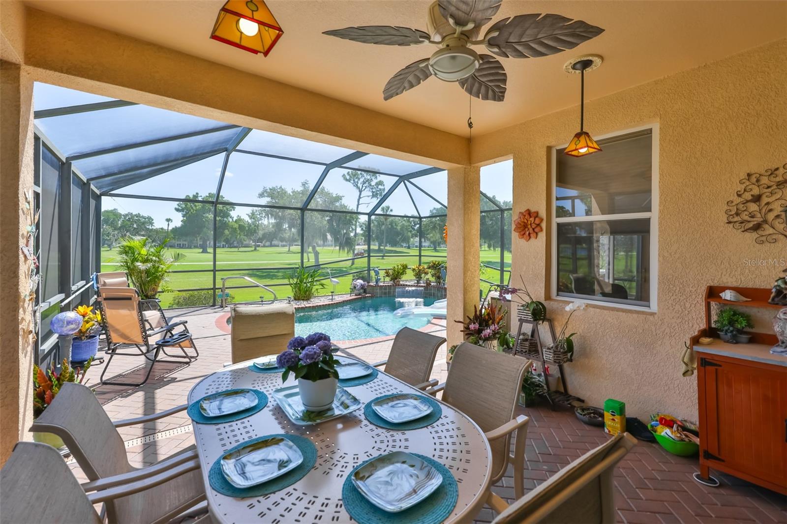Adorable screened in eating area, with blinds for privacy from neighbor. I'm not sure which hole this is on the course, but sure is a lovely view to have.