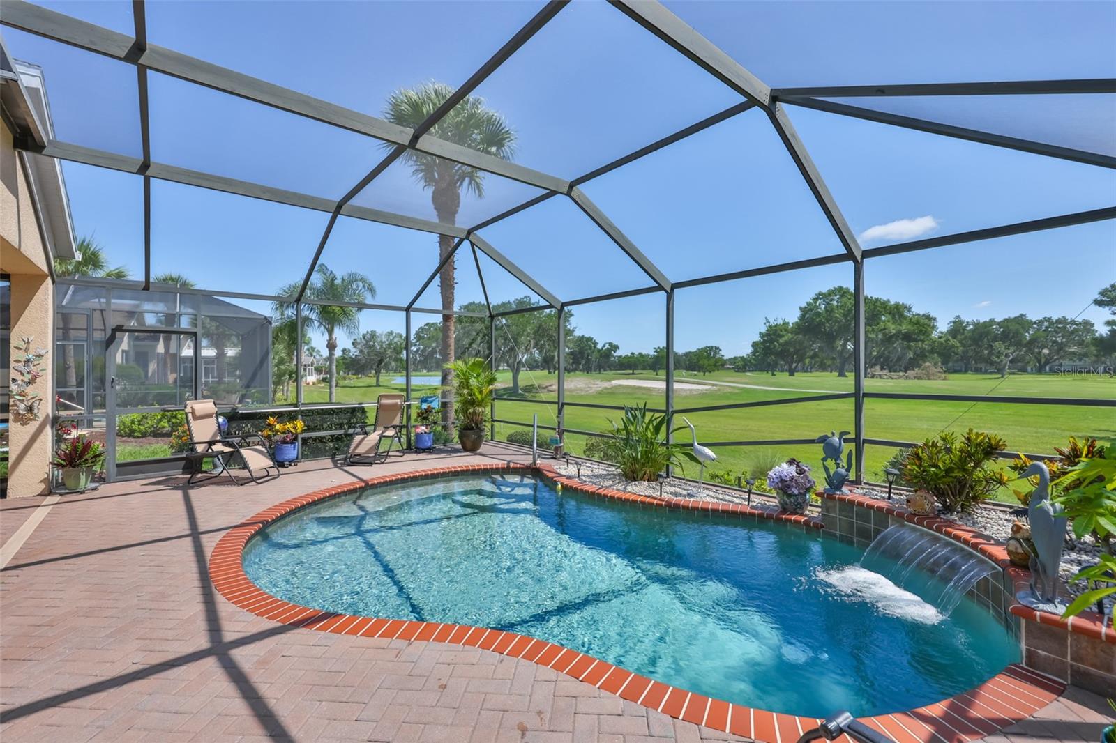 A lovely in-ground waterfall pool makes for great atmosphere and parties or grandkids.